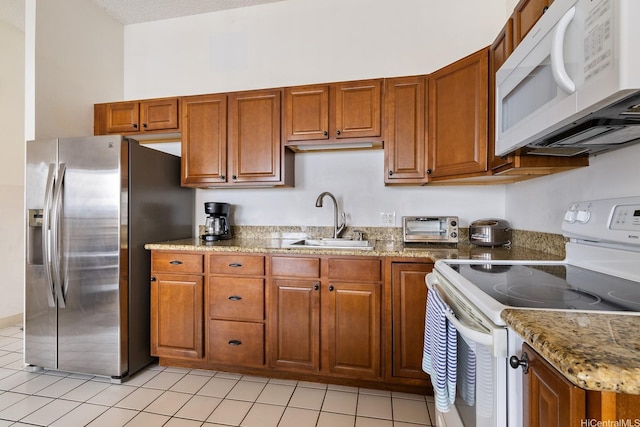 201 Ohua Ave Unit 3702-1, Penthouse Honolulu, HI 96815 - kitchen featuring white appliances, brown cabinets, light tile patterned flooring, and light stone countertops