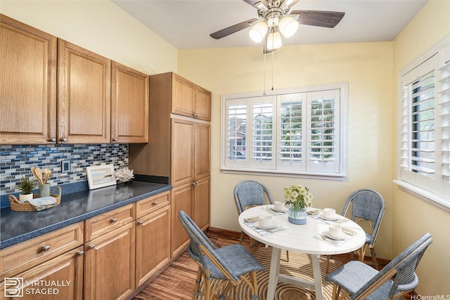 91-1037 Paaoloulu Way, Kapolei, HI 96707 - kitchen featuring ceiling fan, tasteful backsplash, dark countertops, wood finished floors, and brown cabinets