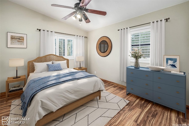 91-1037 Paaoloulu Way, Kapolei, HI 96707 - bedroom with vaulted ceiling, multiple windows, wood finished floors, and a ceiling fan