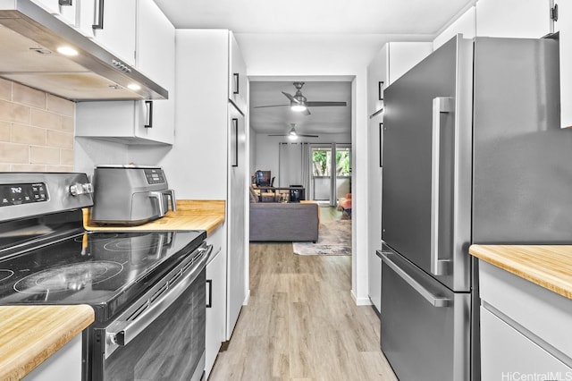 96-226 Waiawa Rd Unit 46, Pearl City, HI 96782 - kitchen featuring stainless steel appliances, under cabinet range hood, light wood finished floors, butcher block counters, and backsplash