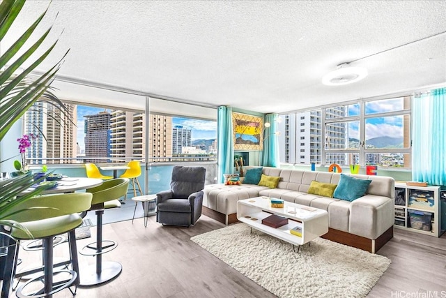 2500 Kalakaua Ave Unit 2103, Honolulu, HI 96815 - living area featuring a city view, a textured ceiling, and wood finished floors