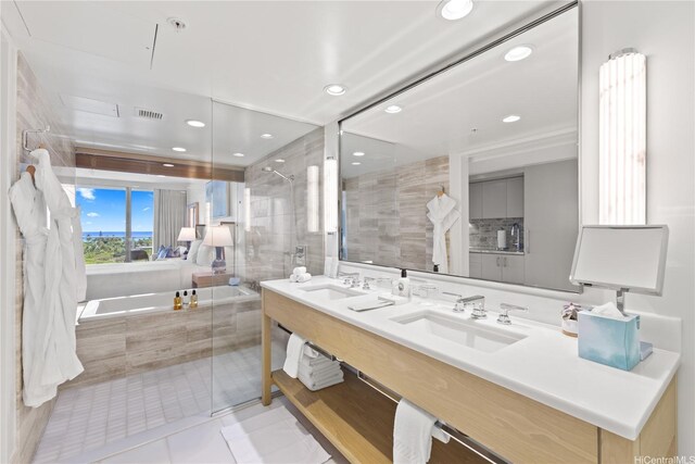 383 Kalaimoku St Unit 1006, Honolulu, HI 96815 - bathroom with double vanity, a garden tub, tile patterned floors, a tile shower, and recessed lighting