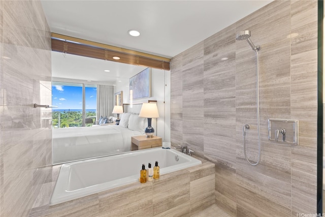 383 Kalaimoku St Unit 1006, Honolulu, HI 96815 - bathroom featuring tiled shower, a garden tub, tile walls, and recessed lighting