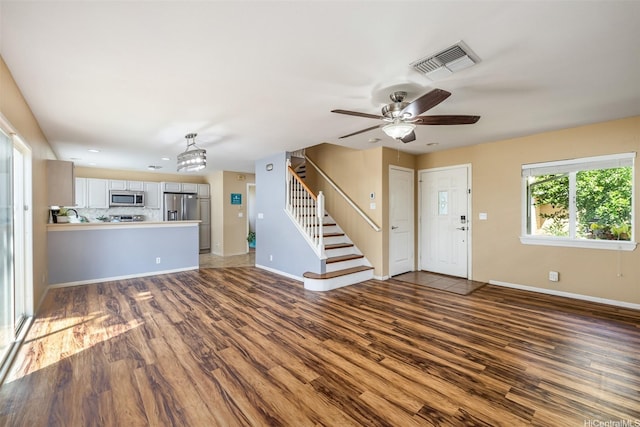 87-2165 Pakeke St Unit 59, Waianae, HI 96792 - unfurnished living room with stairs, wood finished floors, and ceiling fan