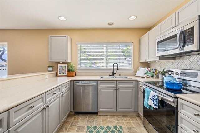 87-2165 Pakeke St Unit 59, Waianae, HI 96792 - kitchen featuring appliances with stainless steel finishes, recessed lighting, gray cabinetry, tasteful backsplash, and light countertops