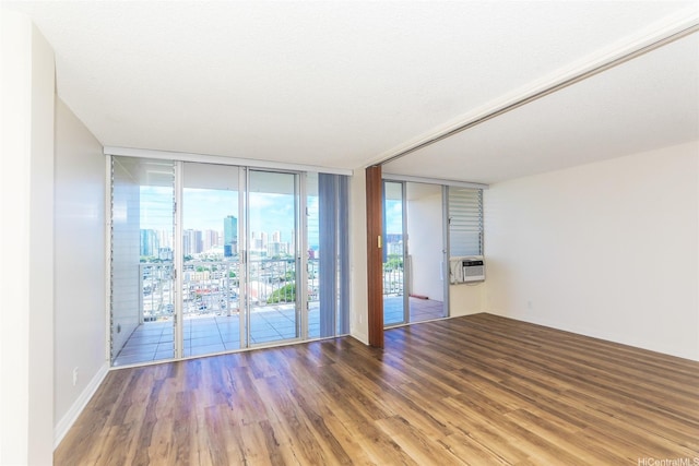 1215 Alexander St Unit 1201, Honolulu, HI 96826 - unfurnished room with wood finished floors, a wall of windows, a view of city, and cooling unit