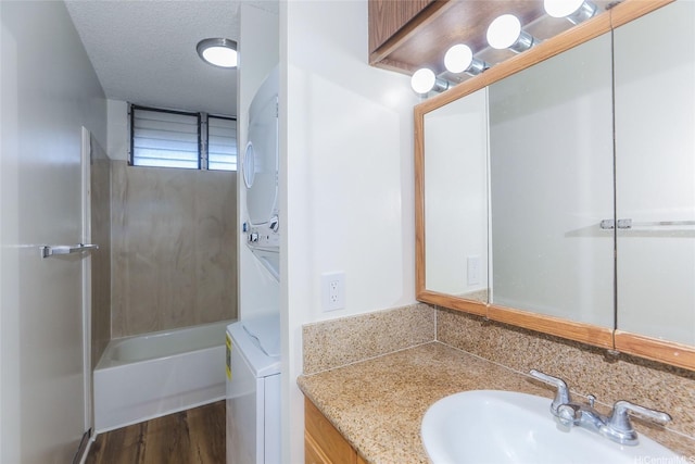 1215 Alexander St Unit 1201, Honolulu, HI 96826 - bathroom with estacked washer and dryer, vanity, and wood finished floors