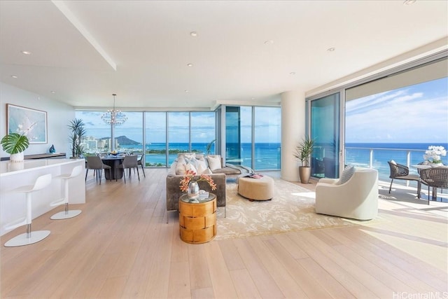 1118 Ala Moana Blvd Unit 2000/2002, Honolulu, HI 96814 - living room with a wall of windows, wood-type flooring, a chandelier, and a water view