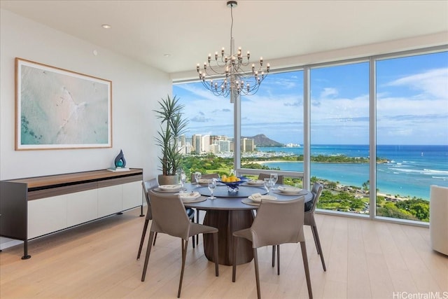 1118 Ala Moana Blvd Unit 2000/2002, Honolulu, HI 96814 - dining area with expansive windows, light wood finished floors, a chandelier, and a water view