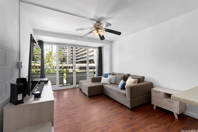 445 Kaiolu St Unit 407, Honolulu, HI 96815 - living area with ceiling fan, dark wood-style flooring, and concrete block wall
