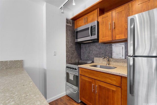 445 Kaiolu St Unit 407, Honolulu, HI 96815 - kitchen featuring stainless steel appliances, brown cabinets, decorative backsplash, and dark wood-type flooring