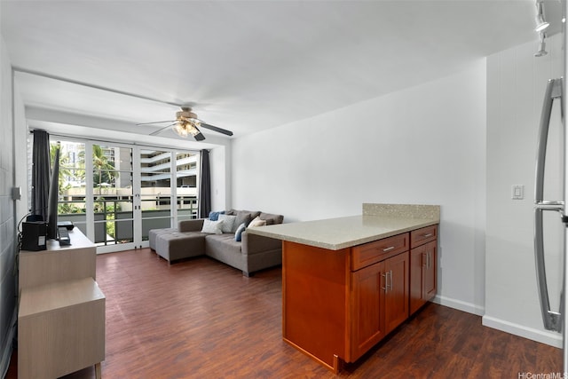 445 Kaiolu St Unit 407, Honolulu, HI 96815 - living room featuring a ceiling fan and dark wood-style flooring