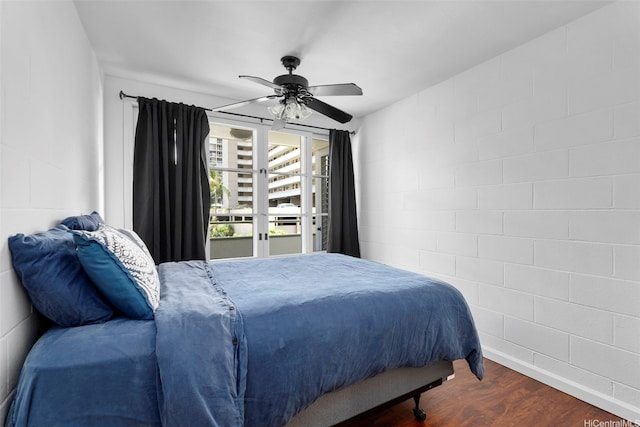 445 Kaiolu St Unit 407, Honolulu, HI 96815 - bedroom with wood finished floors, a ceiling fan, access to exterior, and concrete block wall