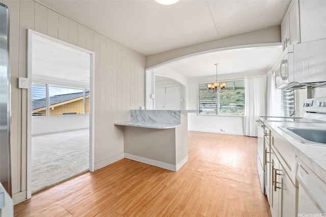 2061 10th Ave, Honolulu, HI 96816 - kitchen with a chandelier, white appliances, arched walkways, and light wood-style floors
