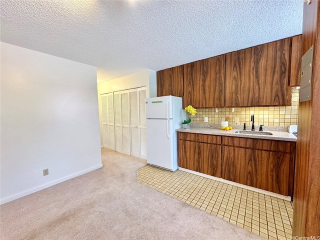 1036 Green St Unit 204, Honolulu, HI 96822 - kitchen with freestanding refrigerator, light countertops, light colored carpet, brown cabinets, and tasteful backsplash