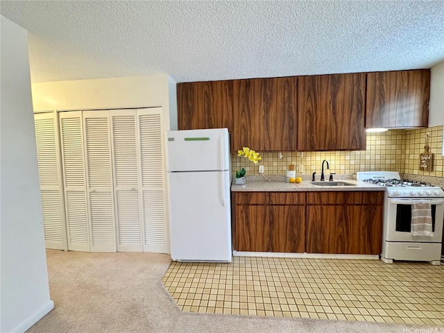 1036 Green St Unit 204, Honolulu, HI 96822 - kitchen with white appliances, light countertops, decorative backsplash, a textured ceiling, and light colored carpet