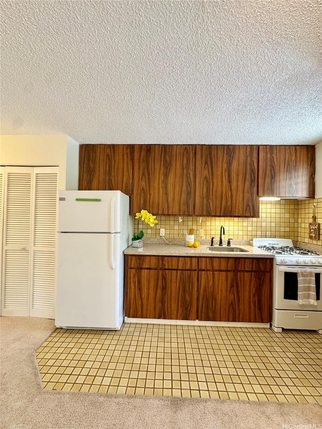 1036 Green St Unit 204, Honolulu, HI 96822 - kitchen with white appliances, light countertops, a textured ceiling, backsplash, and brown cabinetry