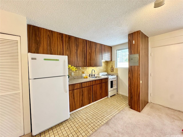 1036 Green St Unit 204, Honolulu, HI 96822 - kitchen with white appliances, light countertops, a textured ceiling, decorative backsplash, and brown cabinetry