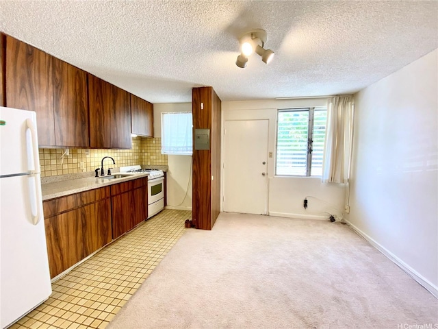 1036 Green St Unit 204, Honolulu, HI 96822 - kitchen featuring white appliances, light countertops, tasteful backsplash, a textured ceiling, and brown cabinets