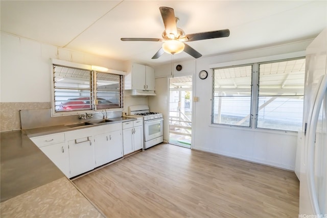 741 Alewa Dr Unit A, Honolulu, HI 96817 - kitchen with white gas range oven, under cabinet range hood, ceiling fan, white cabinets, and light wood-style flooring