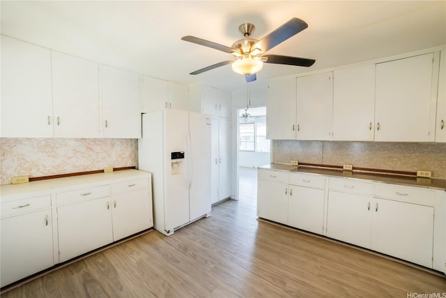 741 Alewa Dr Unit A, Honolulu, HI 96817 - kitchen featuring white fridge with ice dispenser, ceiling fan, backsplash, and white cabinetry