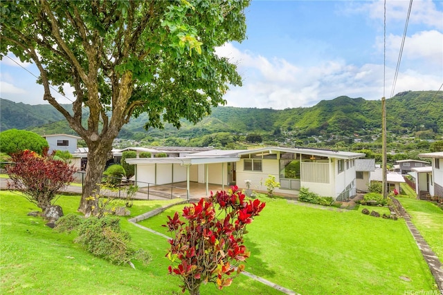 3313 Manoa Rd, Honolulu, HI 96822 - rear view of house with a mountain view, a yard, and a carport