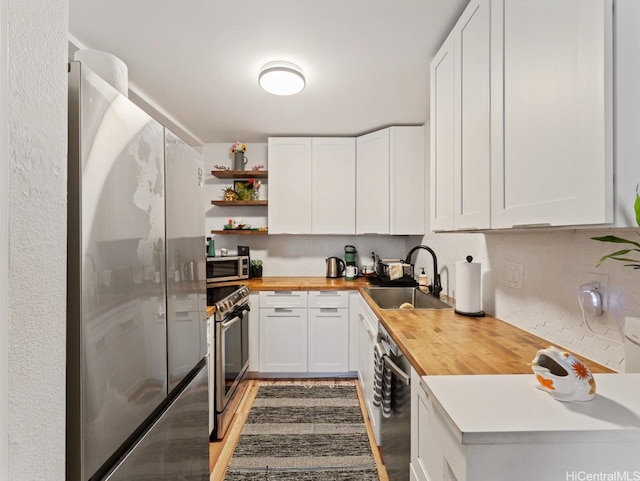 46-63 Emepela Pl Unit P205, Kaneohe, HI 96744 - kitchen featuring butcher block counters, appliances with stainless steel finishes, open shelves, and white cabinets