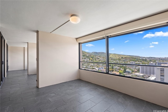 1717 Mott Smith Dr Unit 2811, Honolulu, HI 96822 - empty room with dark tile patterned flooring and a view of city