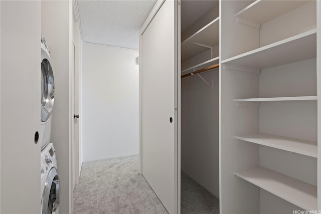 1717 Mott Smith Dr Unit 2811, Honolulu, HI 96822 - washroom featuring estacked washer and dryer and carpet