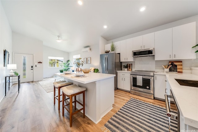 91-1804 Kohanahana Loop, Ewa Beach, HI 96706 - kitchen with appliances with stainless steel finishes, light countertops, a kitchen island, a breakfast bar area, and light wood finished floors