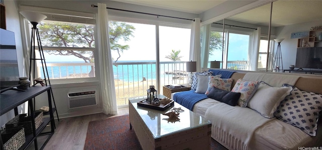 85-175 Farrington Hwy Unit A315, Waianae, HI 96792 - living area with wood finished floors, a water view, plenty of natural light, and a wall mounted air conditioner