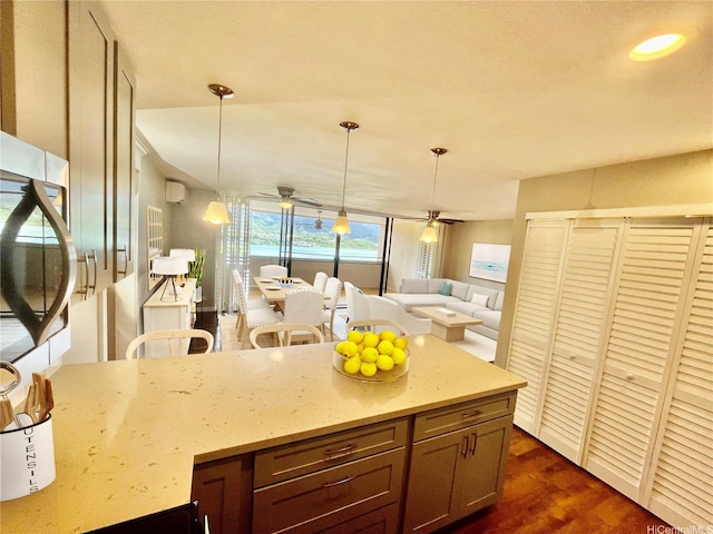46-035 Konohiki St Unit 3832, Kaneohe, HI 96744 - kitchen with light stone counters, dark wood-type flooring, ceiling fan, and hanging light fixtures