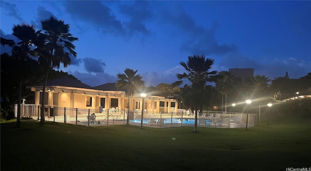 46-035 Konohiki St Unit 3832, Kaneohe, HI 96744 - back of house at twilight with a community pool, stucco siding, and a patio
