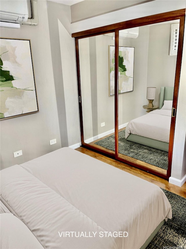 46-035 Konohiki St Unit 3832, Kaneohe, HI 96744 - bedroom featuring wood finished floors and a wall unit AC