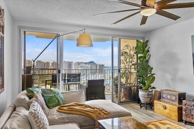 1350 Ala Moana Blvd Unit 3004, Honolulu, HI 96814 - living room with a ceiling fan, wood finished floors, a city view, and a textured ceiling