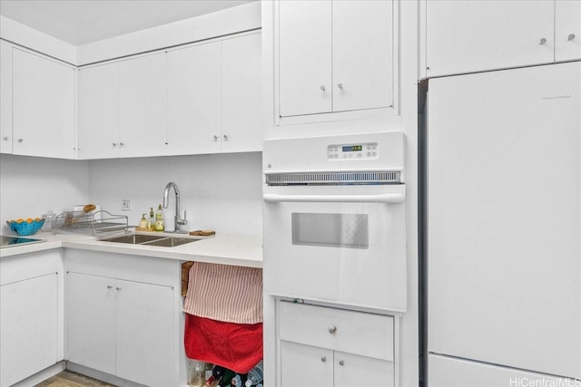 1350 Ala Moana Blvd Unit 3004, Honolulu, HI 96814 - kitchen featuring white appliances, white cabinetry, and light countertops