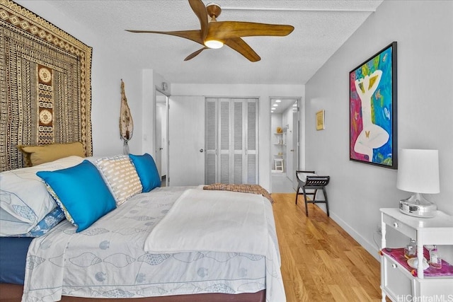 1350 Ala Moana Blvd Unit 3004, Honolulu, HI 96814 - bedroom with wood finished floors, a textured ceiling, ceiling fan, and a closet