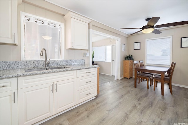 92-1020 Palailai Pl, Kapolei, HI 96707 - kitchen with ceiling fan, light wood-type flooring, white cabinetry, and light stone counters