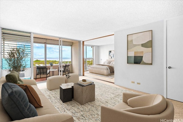 1676 Ala Moana Blvd Unit 1303, Honolulu, HI 96815 - living room featuring a textured ceiling and a wall of windows
