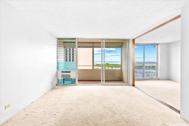 1676 Ala Moana Blvd Unit 1303, Honolulu, HI 96815 - spare room with carpet flooring, a textured ceiling, and cooling unit