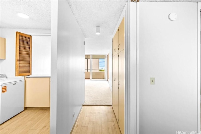 1676 Ala Moana Blvd Unit 1303, Honolulu, HI 96815 - hall featuring washer / dryer, light wood finished floors, and a textured ceiling