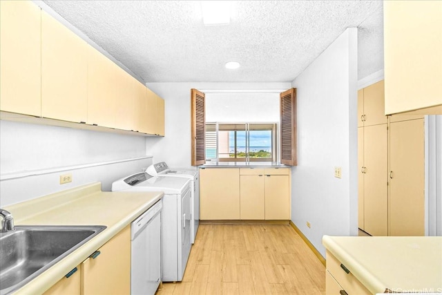 1676 Ala Moana Blvd Unit 1303, Honolulu, HI 96815 - laundry area with a textured ceiling, light wood-style flooring, washing machine and clothes dryer, and cabinet space