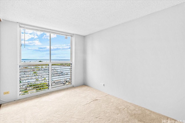 1676 Ala Moana Blvd Unit 1303, Honolulu, HI 96815 - carpeted spare room with a textured ceiling, a water view, and floor to ceiling windows