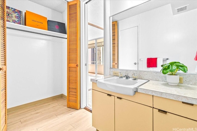 1676 Ala Moana Blvd Unit 1303, Honolulu, HI 96815 - bathroom with wood finished floors, vanity, and a closet