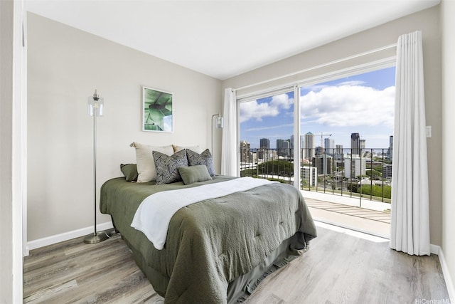 625 Iolani Ave Unit A304, Honolulu, HI 96813 - bedroom with a view of skyline, access to outside, and wood finished floors