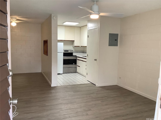1330 Wilder Ave Unit 219, Honolulu, HI 96822 - kitchen featuring stainless steel range with electric stovetop, a ceiling fan, electric panel, and freestanding refrigerator