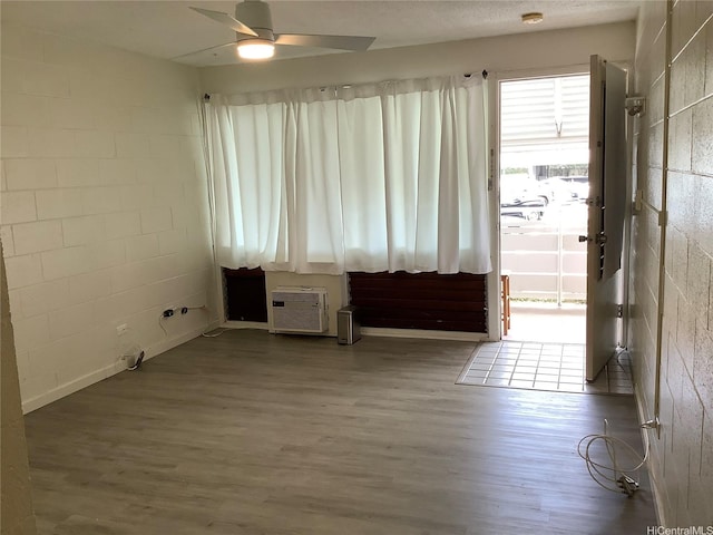 1330 Wilder Ave Unit 219, Honolulu, HI 96822 - spare room with wood finished floors, a ceiling fan, and concrete block wall