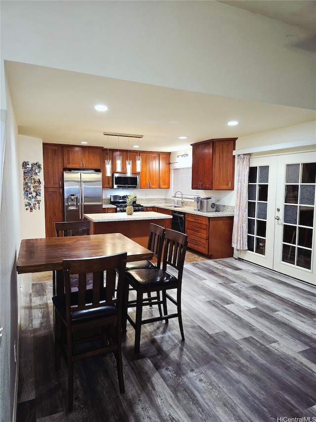 91-1028 Waihuna Pl, Ewa Beach, HI 96706 - kitchen with appliances with stainless steel finishes, dark wood-style flooring, light countertops, french doors, and recessed lighting