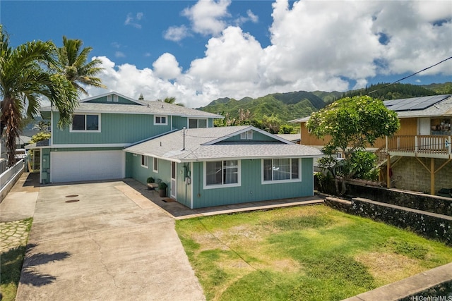 54-18 Haukoi Pl, Hauula, HI 96717 - view of front of property with concrete driveway, a garage, a mountain view, and a shingled roof