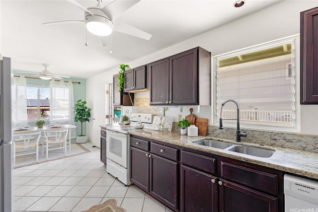 54-18 Haukoi Pl, Hauula, HI 96717 - kitchen with white appliances, ceiling fan, light tile patterned floors, light stone countertops, and dark brown cabinets